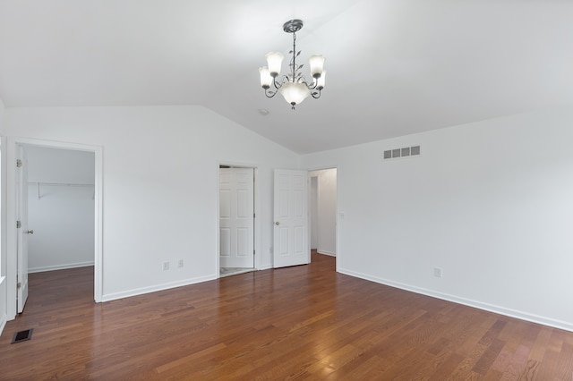 14190 Elmhurst Dr, Sterling Heights, MI 48313 - unfurnished bedroom with a chandelier, lofted ceiling, a walk in closet, wood finished floors, and baseboards