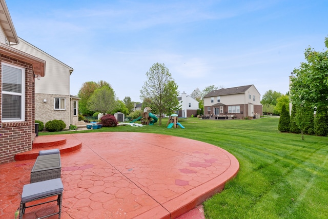 14190 Elmhurst Dr, Sterling Heights, MI 48313 - view of green lawn featuring a playground, a patio area, and a residential view