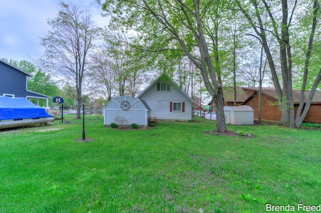 2551 Mayo Dr, Fremont, MI 49412 - view of green lawn featuring a shed and an outbuilding