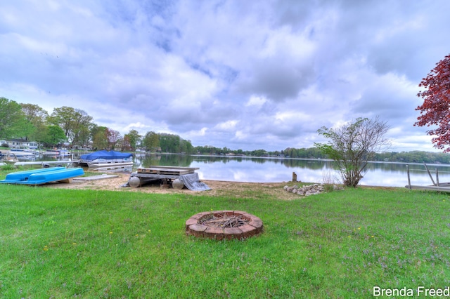 2551 Mayo Dr, Fremont, MI 49412 - dock featuring a lawn, an outdoor fire pit, and a water view
