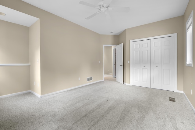 unfurnished bedroom with carpet, baseboards, a closet, and a ceiling fan