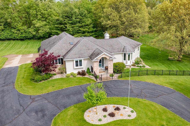 view of front of home featuring driveway and a chimney