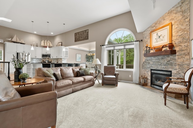 living room featuring light carpet, high vaulted ceiling, and a fireplace