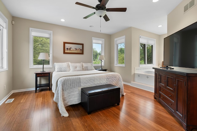 bedroom featuring multiple windows, light wood-type flooring, baseboards, and recessed lighting