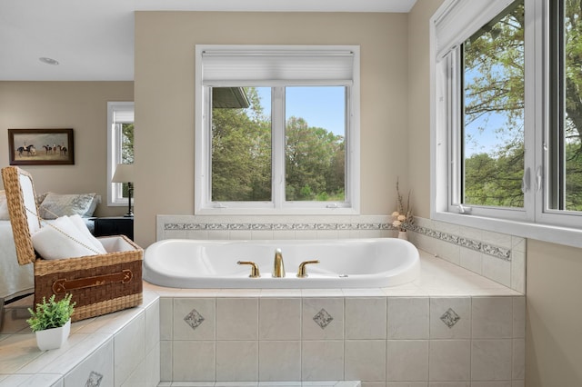 ensuite bathroom featuring plenty of natural light and a bath