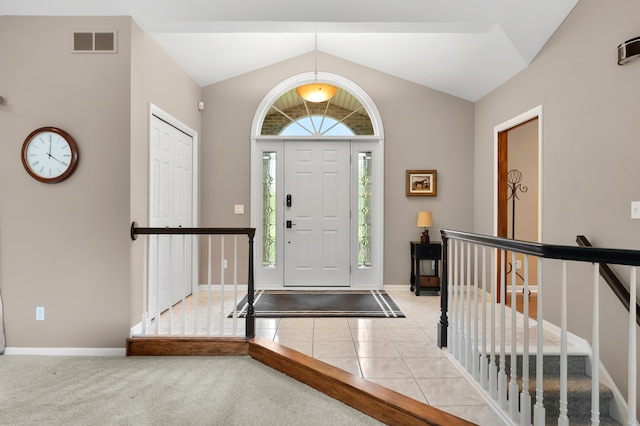 foyer with lofted ceiling and baseboards