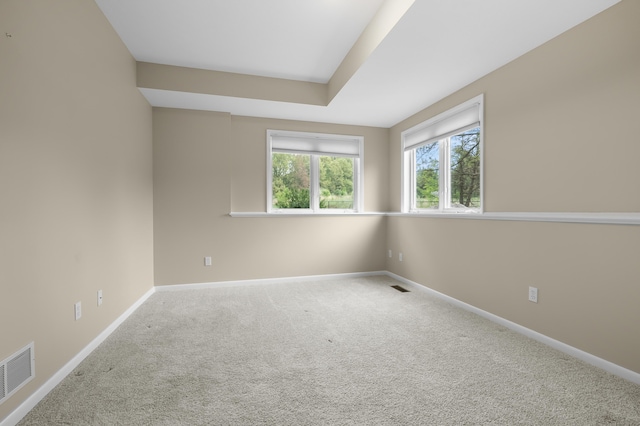spare room with baseboards and carpet