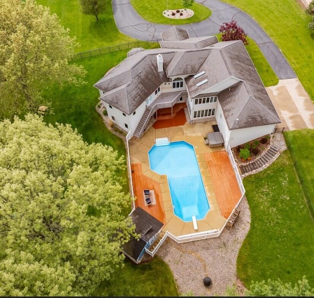 aerial view of property and surrounding area featuring a pool