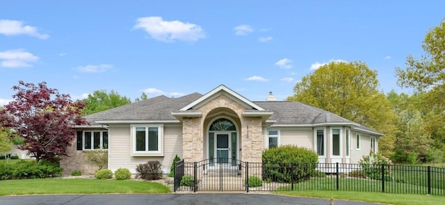 view of front of house with a gate and stone siding