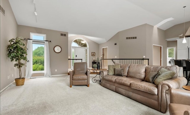 living area with carpet, vaulted ceiling, and baseboards