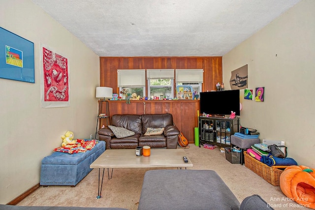 living area featuring carpet and wood walls