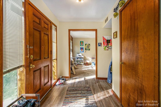 entryway featuring dark wood-style flooring and baseboards