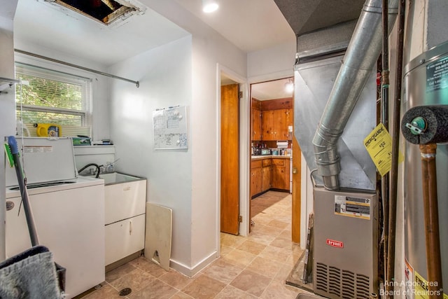 clothes washing area featuring washer / clothes dryer, baseboards, and heating unit