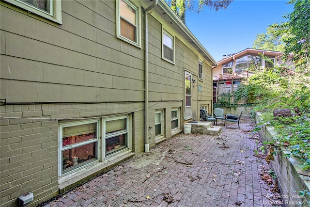 view of side of home with a patio area