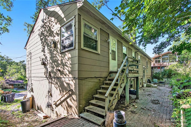 view of property exterior featuring stairs and a patio area
