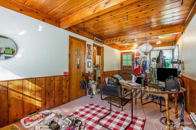 living area with wooden walls, a wainscoted wall, carpet flooring, a desk, and wooden ceiling