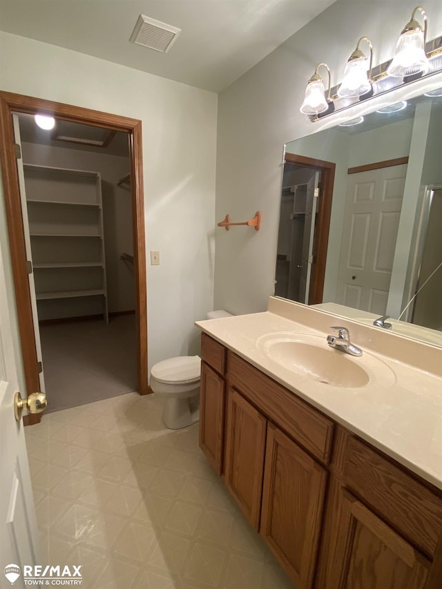 bathroom with tile patterned floors, toilet, and vanity