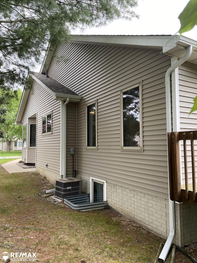rear view of property with central AC unit