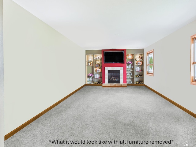 5015 Piehl Rd, Ottawa Lake, MI 49267 - unfurnished living room with a tiled fireplace, carpet floors, and baseboards