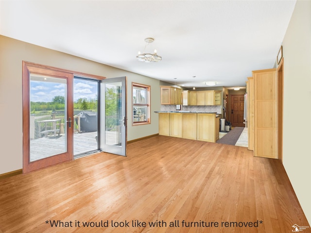 5015 Piehl Rd, Ottawa Lake, MI 49267 - kitchen with light brown cabinets, a peninsula, light wood-style floors, and a chandelier