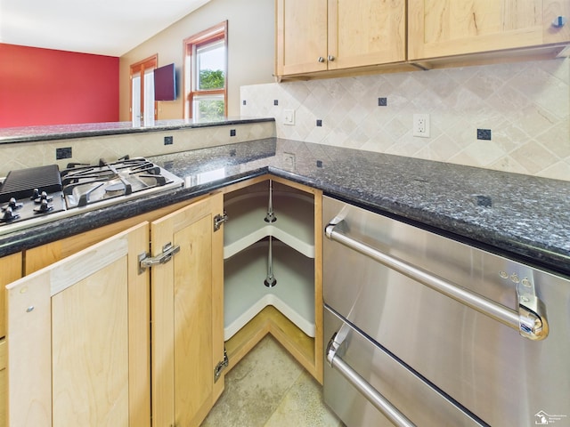 5015 Piehl Rd, Ottawa Lake, MI 49267 - kitchen featuring gas stovetop, decorative backsplash, light brown cabinetry, and dark stone countertops