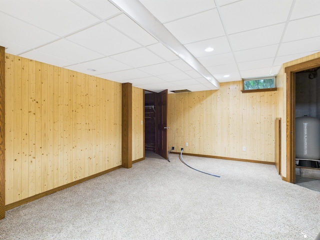 5015 Piehl Rd, Ottawa Lake, MI 49267 - basement featuring carpet floors, a drop ceiling, wooden walls, and a water pressure tank
