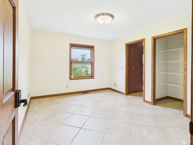 5015 Piehl Rd, Ottawa Lake, MI 49267 - unfurnished bedroom featuring light tile patterned floors and baseboards