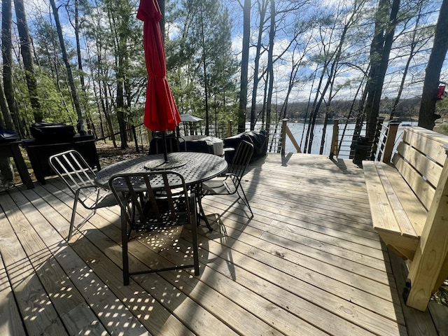 9600 S Oxeye, Baldwin, MI 49304 - wooden terrace featuring outdoor dining area and a water view