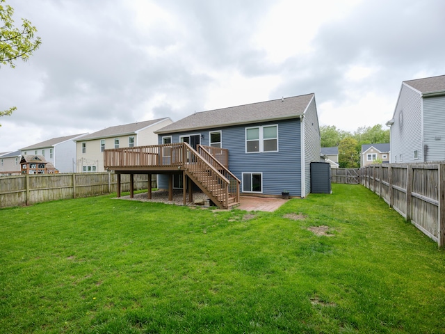 back of property with stairway, a wooden deck, and a patio area