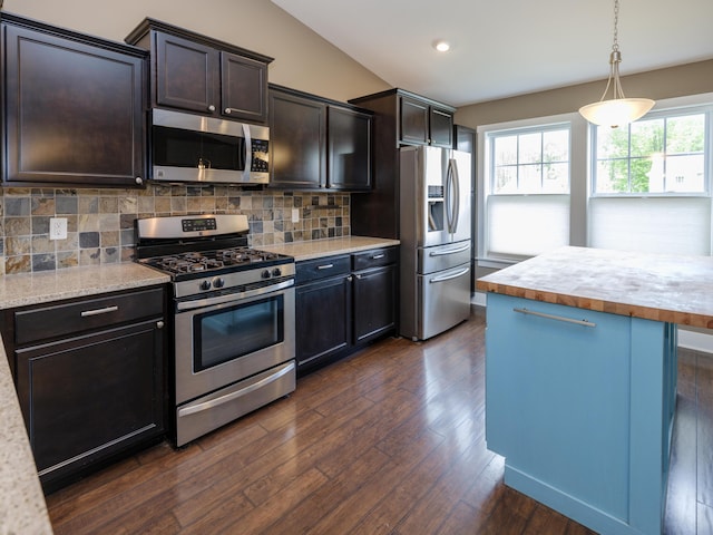 kitchen with appliances with stainless steel finishes, dark wood finished floors, tasteful backsplash, dark brown cabinetry, and recessed lighting