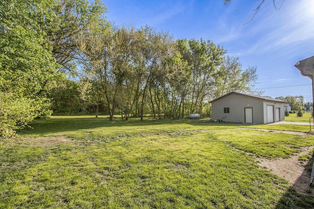 115 E X Y Ave, Vicksburg, MI 49097 - view of green lawn with a garage and an outbuilding