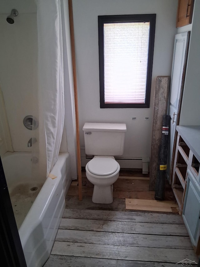 908 Lansing Ave, Jackson, MI 49202 - bathroom with hardwood / wood-style flooring, baseboard heating, toilet, and shower / bath combo with shower curtain