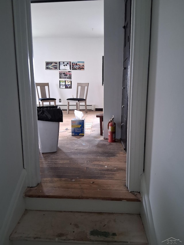 908 Lansing Ave, Jackson, MI 49202 - hallway featuring wood finished floors and baseboard heating