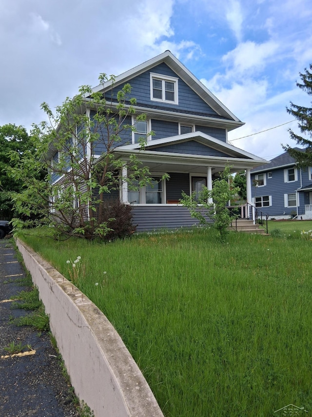 908 Lansing Ave, Jackson, MI 49202 - view of front facade with covered porch and a front yard