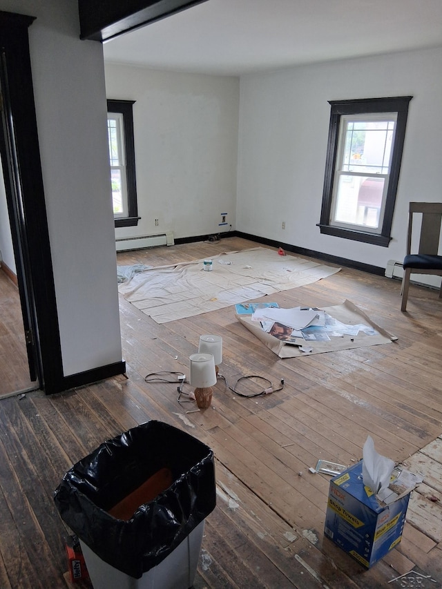 908 Lansing Ave, Jackson, MI 49202 - living room with a baseboard heating unit, plenty of natural light, hardwood / wood-style flooring, and baseboards