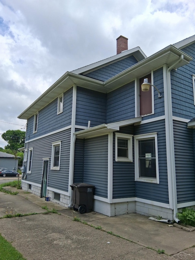 908 Lansing Ave, Jackson, MI 49202 - view of side of property featuring a chimney