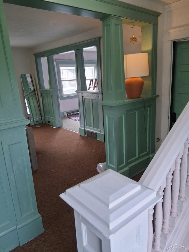 908 Lansing Ave, Jackson, MI 49202 - hallway with dark carpet, ornate columns, and stairs