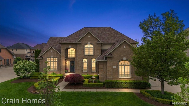 49729 Sandra Dr, Shelby Twp, MI 48315 - view of front of house with brick siding and a yard