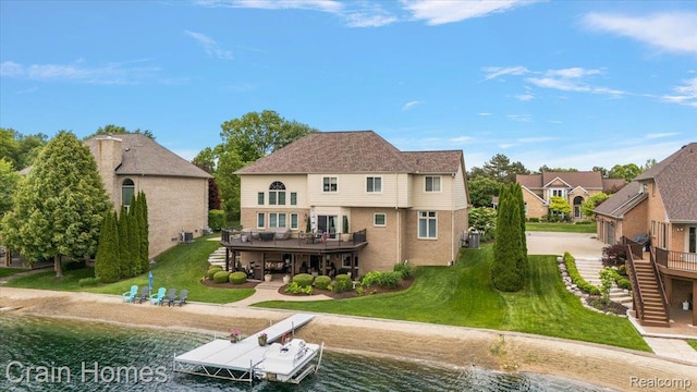 49729 Sandra Dr, Shelby Twp, MI 48315 - rear view of property with stairway, a deck with water view, a yard, and a patio area