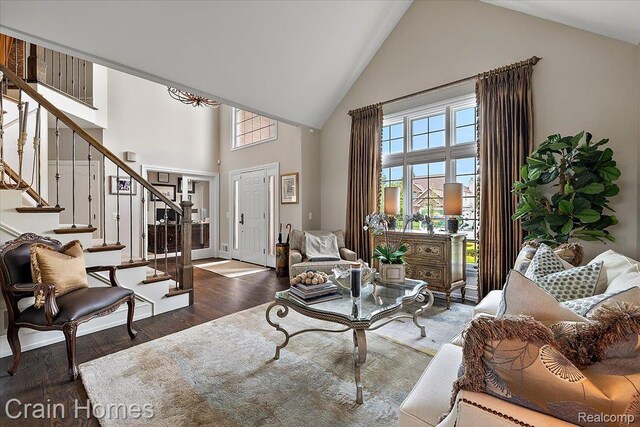 49729 Sandra Dr, Shelby Twp, MI 48315 - living room featuring high vaulted ceiling, plenty of natural light, stairs, and wood finished floors