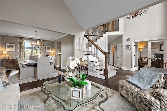 49729 Sandra Dr, Shelby Twp, MI 48315 - living room featuring high vaulted ceiling, wood finished floors, stairway, a chandelier, and crown molding