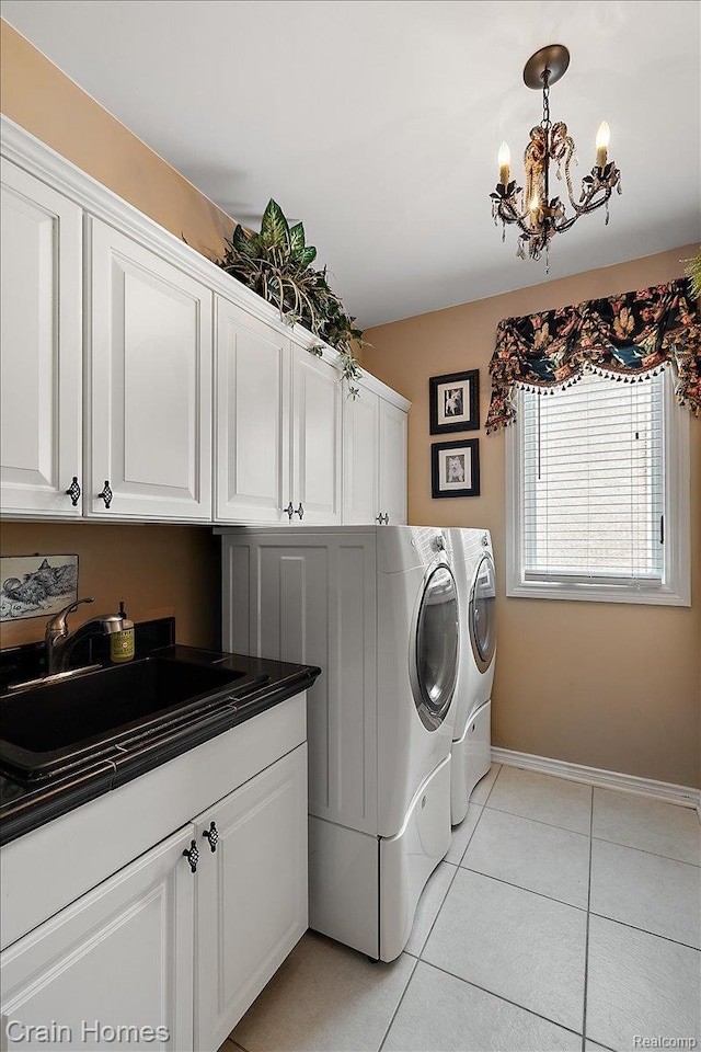 49729 Sandra Dr, Shelby Twp, MI 48315 - washroom featuring cabinet space, washer and clothes dryer, a chandelier, light tile patterned floors, and baseboards