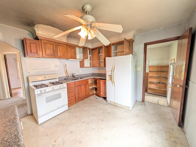24573 Stewart Ave, Warren, MI 48089 - kitchen featuring white appliances, light flooring, brown cabinetry, ceiling fan, and a sink