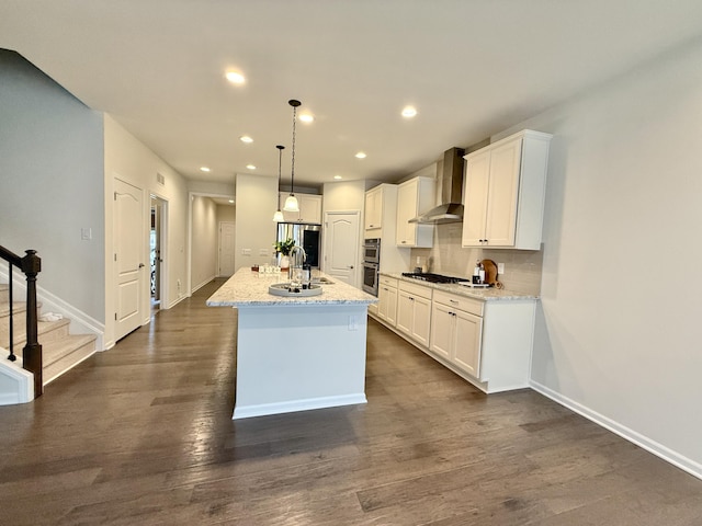 2763 Polson St, Ann Arbor, MI 48105 - kitchen with wall chimney range hood, a sink, stainless steel appliances, white cabinetry, and recessed lighting