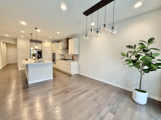 2763 Polson St, Ann Arbor, MI 48105 - kitchen with wall chimney range hood, a sink, stainless steel appliances, dark wood-style floors, and white cabinets
