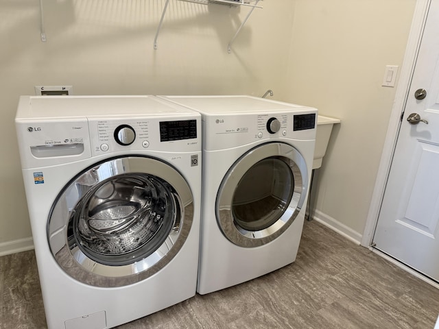2763 Polson St, Ann Arbor, MI 48105 - laundry area featuring washing machine and clothes dryer and baseboards