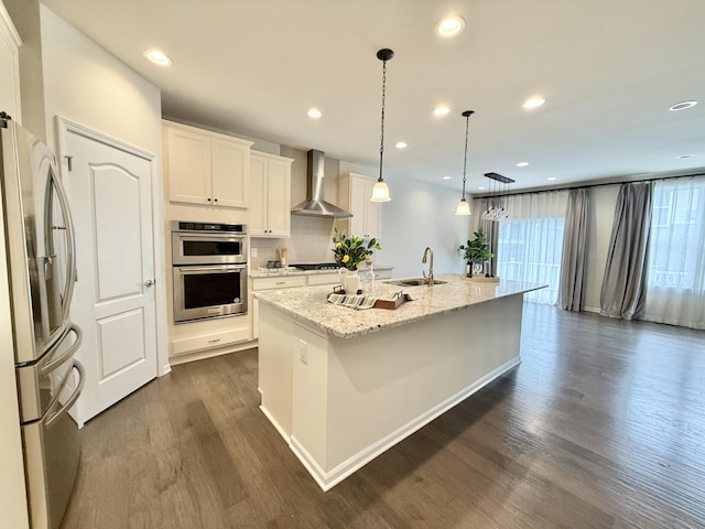 2763 Polson St, Ann Arbor, MI 48105 - kitchen featuring stainless steel appliances, wall chimney exhaust hood, a sink, dark wood finished floors, and a kitchen island with sink