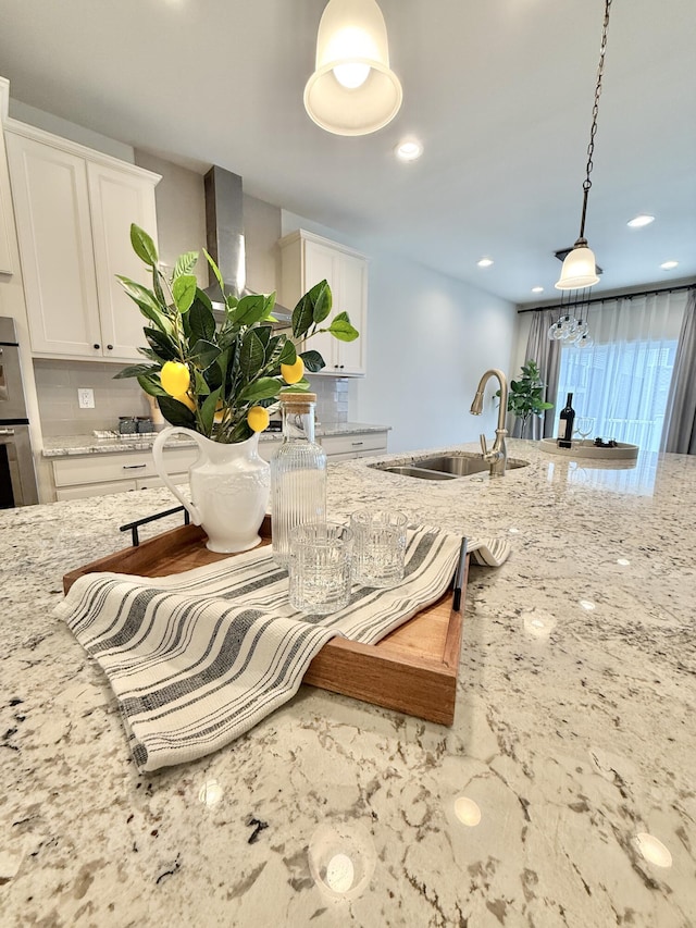 2763 Polson St, Ann Arbor, MI 48105 - kitchen with a sink, decorative backsplash, light stone countertops, hanging light fixtures, and recessed lighting