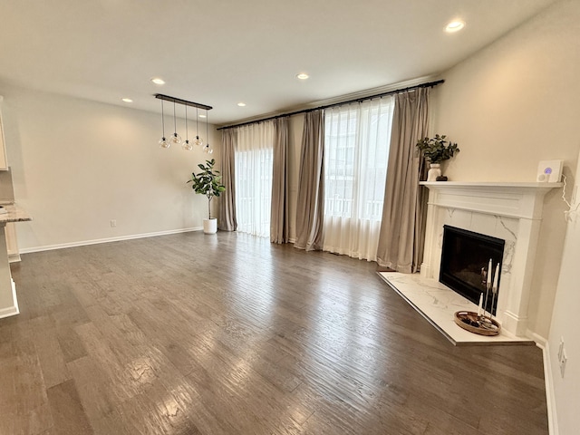 2763 Polson St, Ann Arbor, MI 48105 - unfurnished living room with dark wood-style flooring, a fireplace, recessed lighting, and baseboards