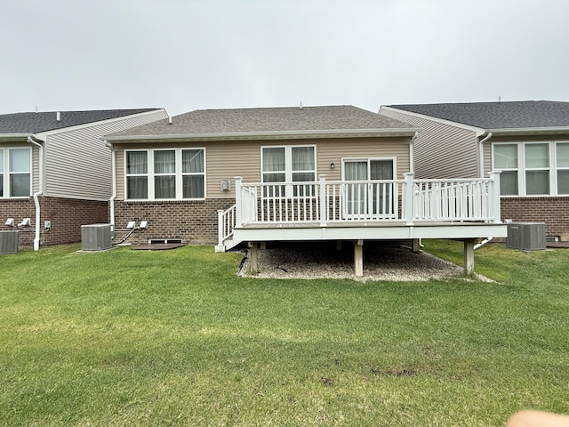 2763 Polson St, Ann Arbor, MI 48105 - rear view of property featuring a deck, central AC, brick siding, and a yard